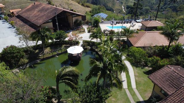 Aerial view of the lodge among gardens and forest