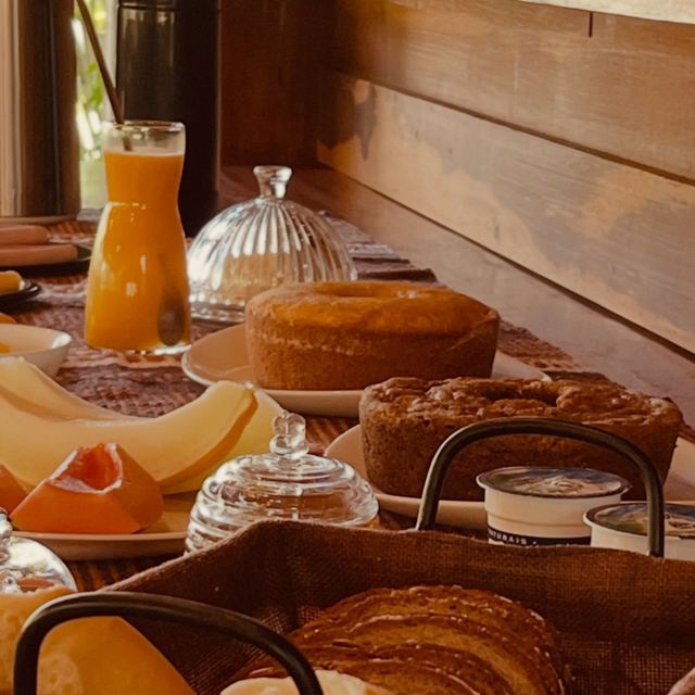 Breakfast table with cakes, fruit and juice