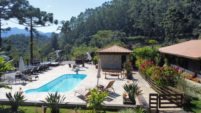 Pool with loungers and mountains behind