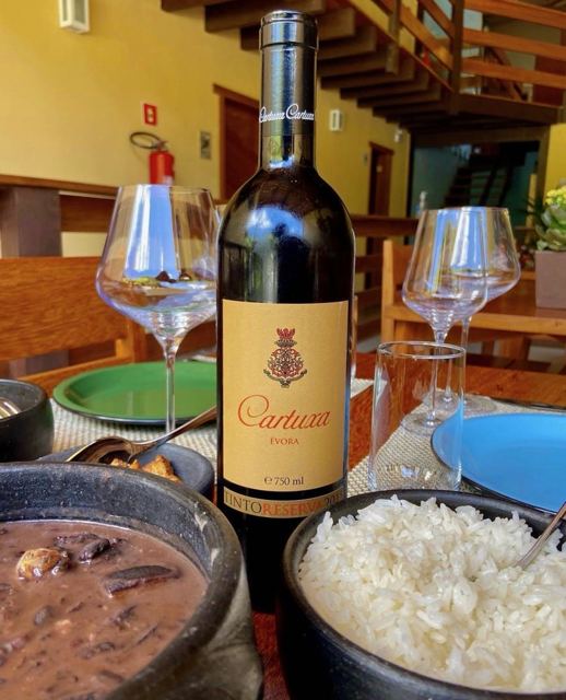 Feijoada with red wine at the restaurant table