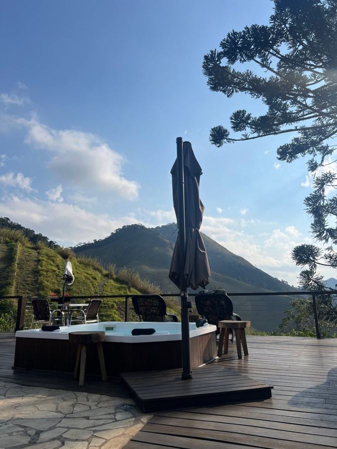 Hot tub on the deck with the mountain and an araucaria behind