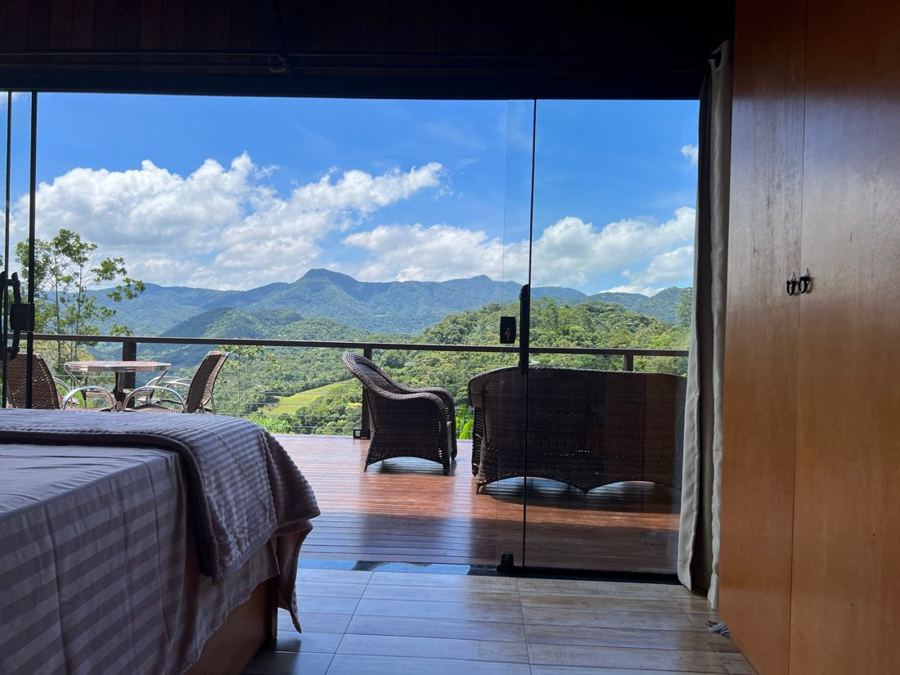 Chalet bedroom opening onto the deck, mountains behind